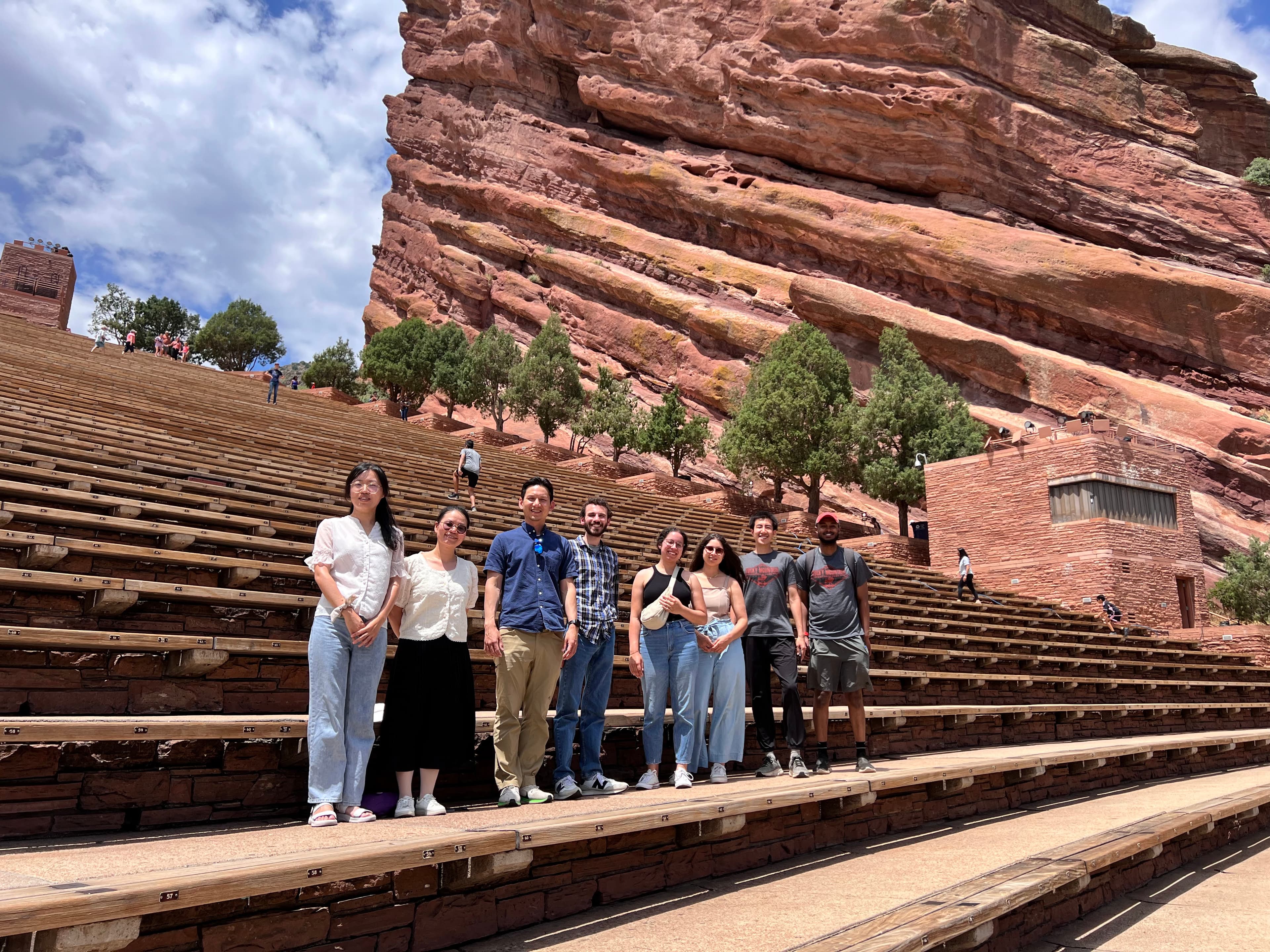 Young Disciples members gathered together on the steps of an outdoor amphitheatre